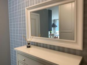 a bathroom with a mirror and a white sink at Nida in Nida