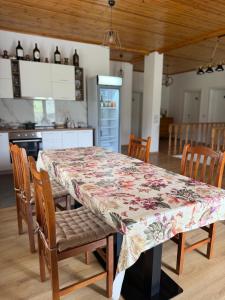 a kitchen with a table with a floral table cloth on it at Bujtina Lugina e vjosës in Përmet