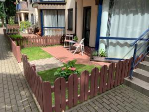 a wooden fence in front of a house at Nida in Nida