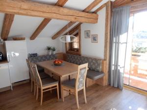 a kitchen and dining room with a wooden table and chairs at Häuserhof in Stumm