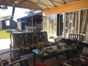 a screened in porch with a table and chairs and a table and chairs at Femyli rooms in Shekhvetili