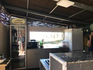 a kitchen with a refrigerator and a counter top at Femyli rooms in Shekhvetili