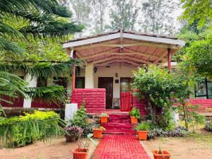 a house with a red carpet in front of it at Wild Valley Club in Masinagudi +27 photos