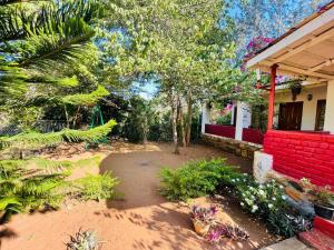 a garden in front of a house with plants at Wild Valley Club in Masinagudi