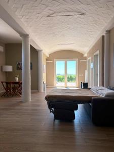 a large bedroom with a large bed and a large window at Villa Iris in Imola