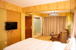 a hotel room with a bed and a television at Nag Pukhu Guest House in Bhaktapur