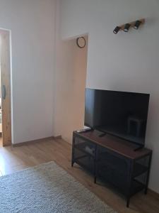 a living room with a flat screen tv on a table at Pine House Novalja in Gajac