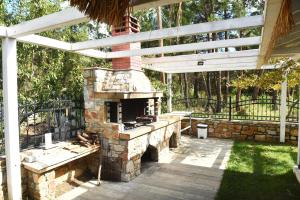 a patio with an outdoor oven in a yard at Laida studios in Prinos