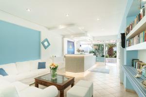 a living room with a white couch and a table at Saraya Resort in Alinda