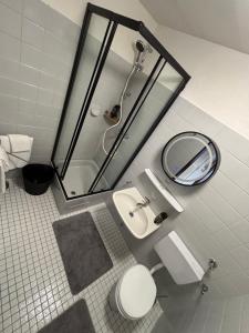 a bathroom with a toilet and a sink and a mirror at Bright studio-flat near station - Bayreuth in Bayreuth
