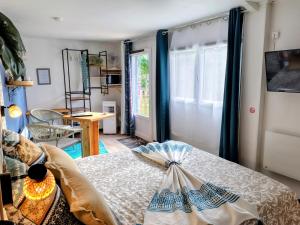 a bedroom with a bed in a room with a window at Le Clos des Passiflores in Pons
