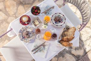 a white table with breakfast foods and drinks on it at casa PRIANI in Krasica