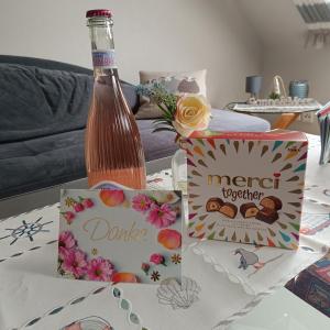 a table with a bottle of drink and a box at Marschblick in Sudermarsch +22 photos