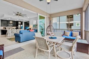 a living room with a table and chairs at One Happy Condo in Bradenton