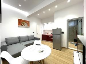a living room with a couch and a table at Vila KAM in Vlorë
