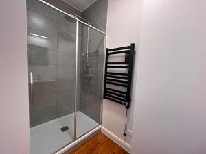 a shower with a glass door in a bathroom at Le Clos des Marronniers in Léglise +30 photos