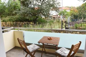 a table and chairs on a balcony with a view at Laida studios in Prinos
