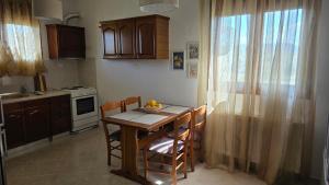 a kitchen with a table and chairs and a kitchen with a stove at Anemos House Sykia Halkidiki in Sykia Chalkidikis