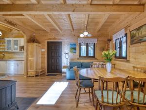 a dining room and living room with a table and chairs at Na Las Czas in Sompolno