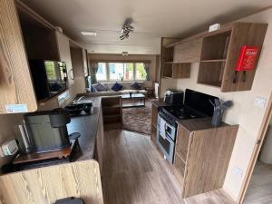a kitchen and living room of a caravan at Elite Retreat Caravan in Blackpool