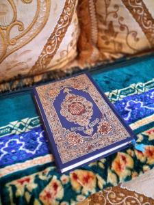 a purple book sitting on top of a bed at Martil Beach Apartment in Martil
