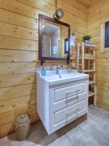 a bathroom with a white sink and a mirror at Na Las Czas in Sompolno +17 photos