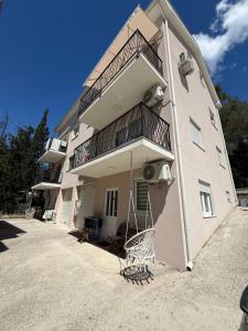 a apartment building with a basketball hoop in front of it at Apartman Holiday in Tivat
