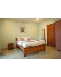 a bedroom with a bed with a wooden frame at Wanderpals Guwahati in Guwahati