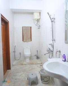 a bathroom with a toilet and a sink at Wanderpals Guwahati in Guwahati