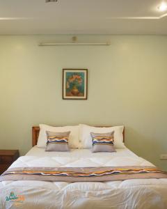 a bedroom with a bed with two pillows on it at Wanderpals Guwahati in Guwahati +28 photos