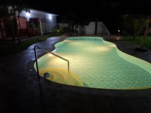 a swimming pool at night with lights in it at Ferienhaus Vacation Villa Diani Beach in Kinondo