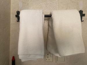 two towels hanging on a towel rack in a bathroom at RUBA apartment in Dammam