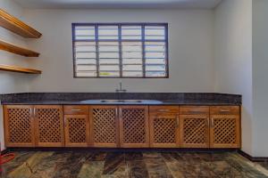 a kitchen with a sink and a window at Solana Pearl Beach Private Villa in Tiwi +53 photos