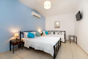 a bedroom with two beds and a tv at Stelios Place in Perissa +76 photos