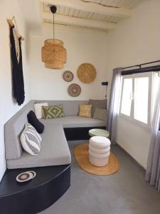 a living room with a couch and a table at Syros-house in Azolimnos Syros +68 photos
