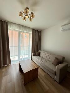 a living room with a couch and a coffee table at Justinrent PALATIUM 31 in Legnica