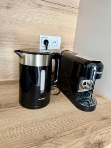 a coffee pot sitting on a counter next to a laptop at Justinrent PALATIUM 31 in Legnica