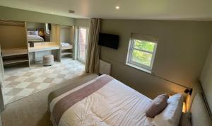 a bedroom with a bed and a window at Riverside Stay in Morpeth