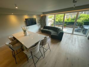 a living room with a table and a couch at Riverside Stay in Morpeth