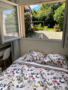 a bed in a room with a window at Les clés du temps in Essarts
