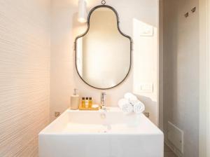 a bathroom with a white sink and a mirror at Dimora Anna - Exclusive Sea Loft in Bari