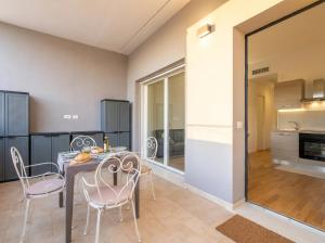 a kitchen and dining room with a table and chairs at Dimora Anna - Exclusive Sea Loft in Bari +12 photos