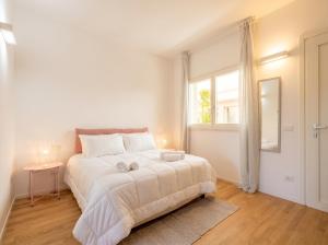 a white bedroom with a large bed and a window at Dimora Anna - Exclusive Sea Loft in Bari