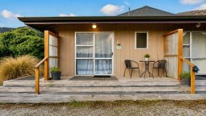 a house with a porch with a table and chairs at The Crossing Lodge in National Park