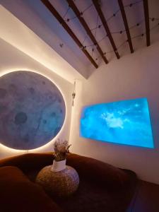 a living room with a couch and a large screen television at Hiraya Luna in Manila