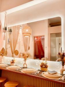 a dining table with plates and a mirror at Hiraya Luna in Manila