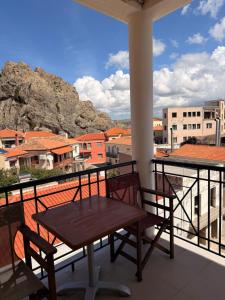 a table and chairs on a balcony with a view at Hotel Lemnos in Myrina
