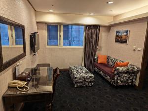 a hotel room with a couch and a table at Cai She Hotel in Taipei +34 photos