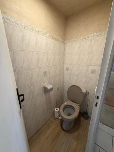 a small bathroom with a toilet in a room at Maison de bourg de village in Dame-Marie-les-Bois