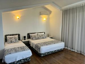 a hotel room with two beds and curtains at Apartment Dasic in Bar